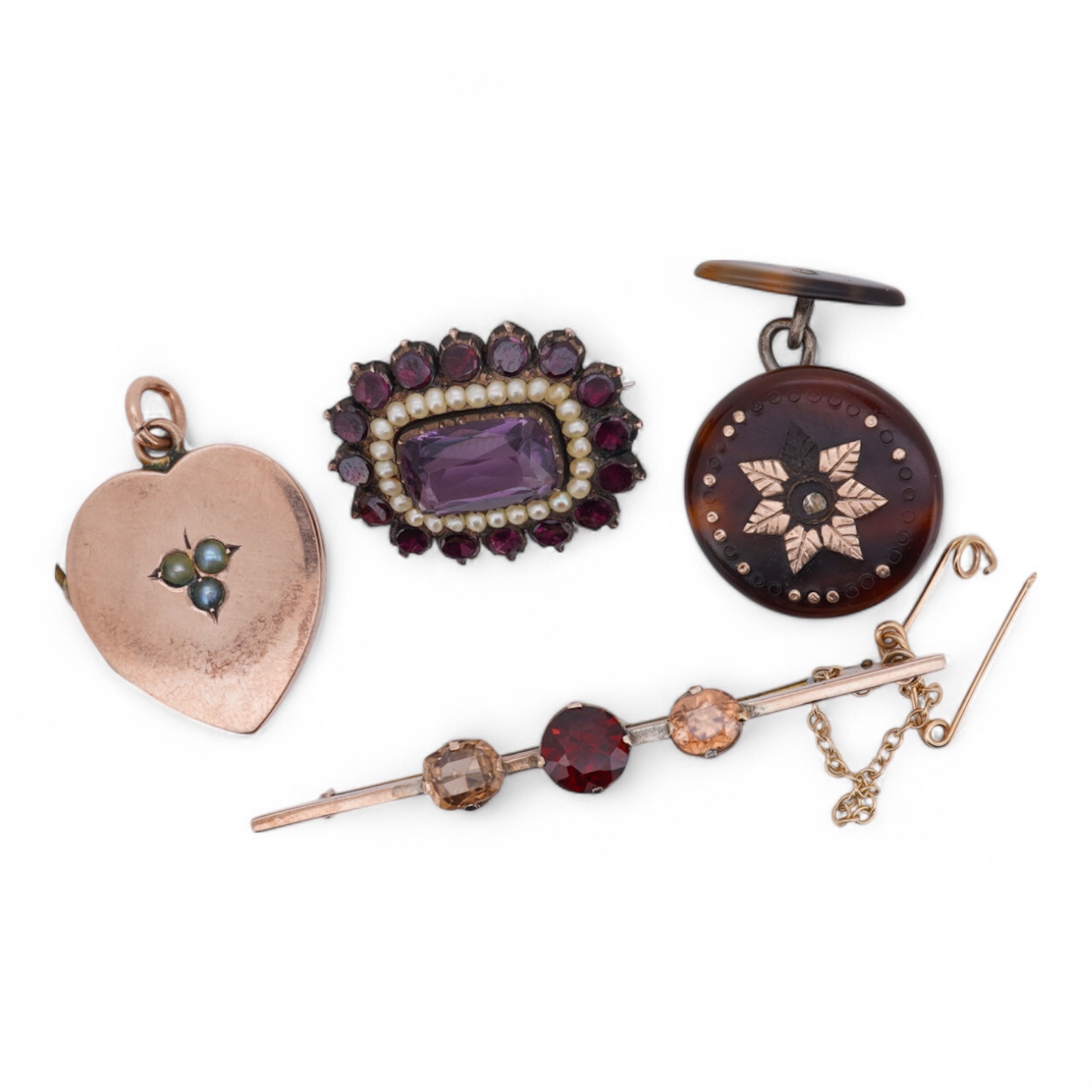 A Victorian yellow metal, amethyst and garnet cluster set brooch, 22mm, an early 20th century yellow metal and seed pearl set heart shaped locket, a yellow metal, garnet and zircon set three stone bar brooch and a tortoi